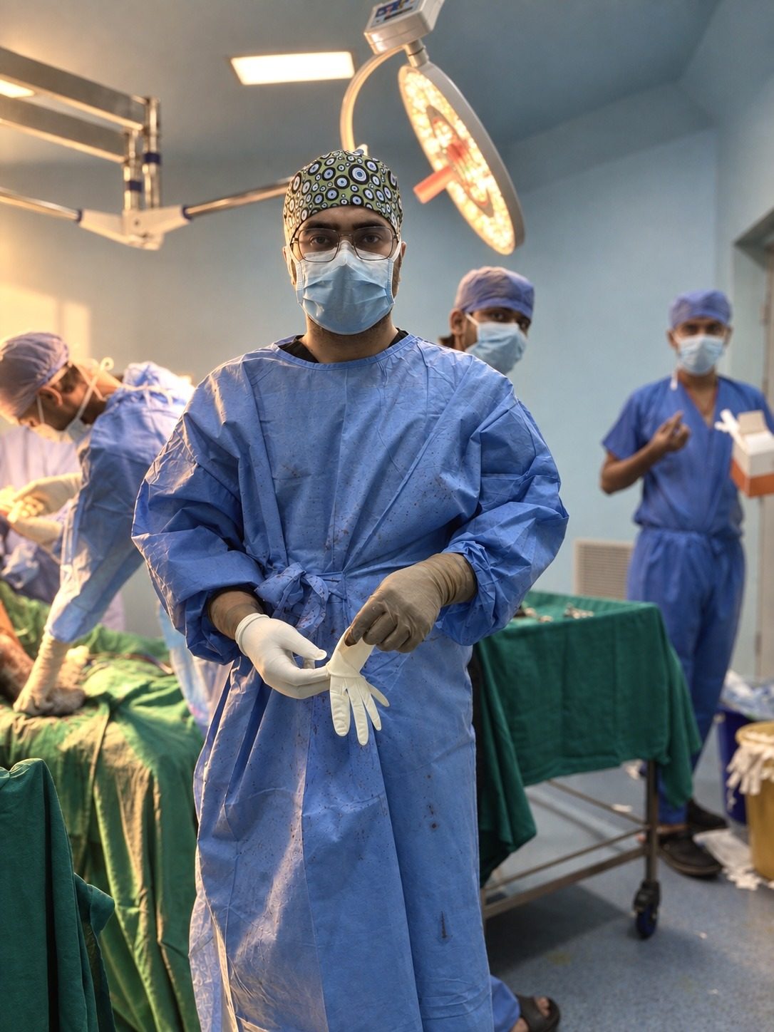 Dr. Ishan Khanna in the operating theatre, in a surgical gown and mask